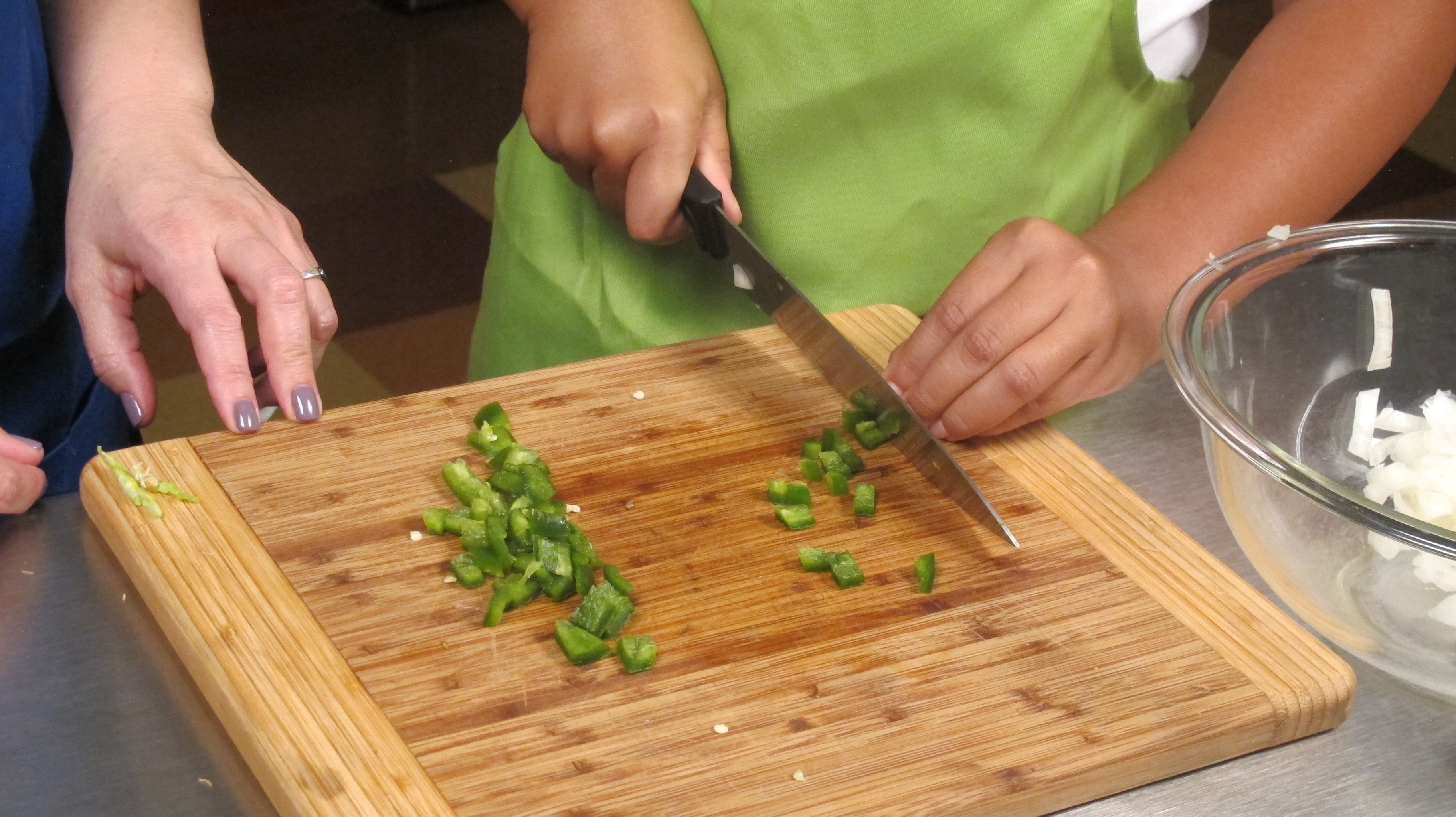 Cut peppers in half and gently remove core and seeds. Cute off stem. Throw away core, seeds and stem. Chop remainder of pepper and add to bowl.