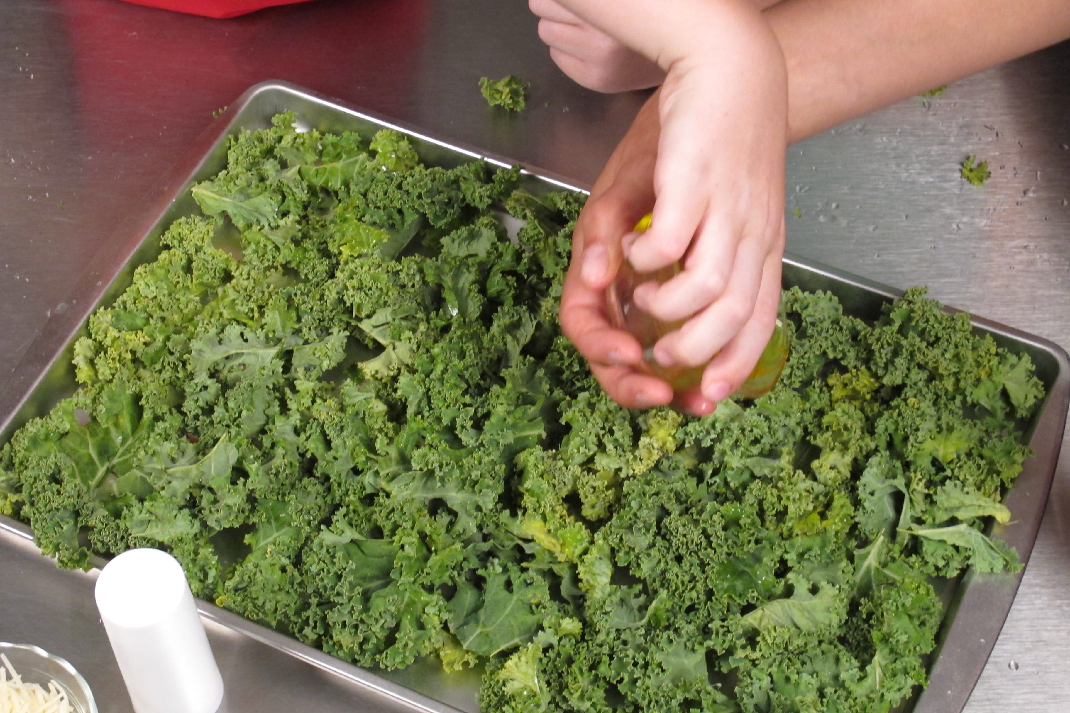Drizzle olive oil over kale.