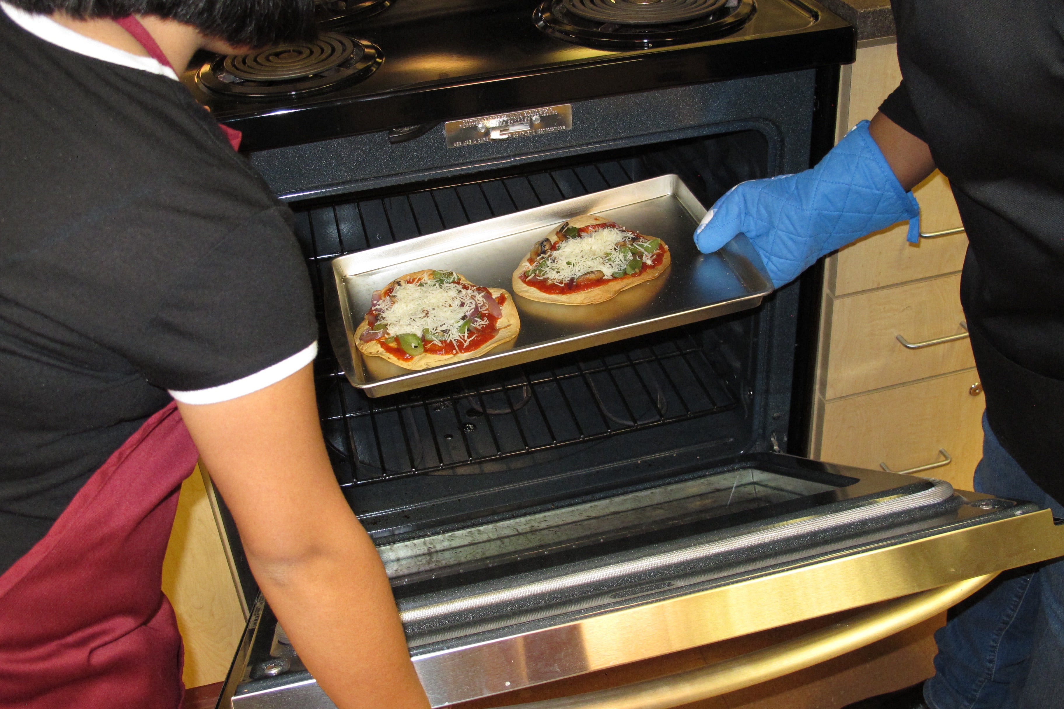 Transfer pizzas to baking sheet. Cook in oven until cheese is melted and edges of tortillas are golden brown, about 10 minutes.